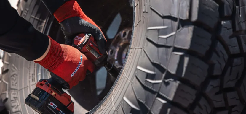 Technician mounting a tire during routine tire service
