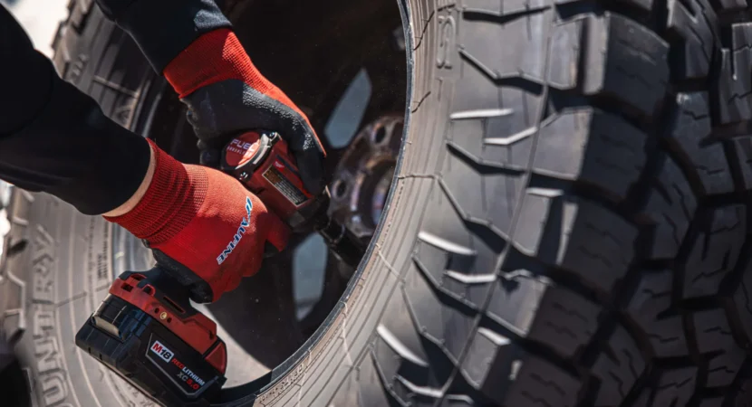 Technician mounting a tire during routine tire service